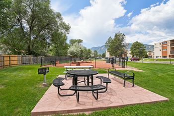 A picnic table and chairs are set up on a patio